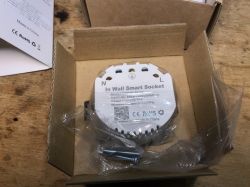 SWP86-01OG smart socket in box SWP86-01OG WiFi smart socket in packaging, wrapped in plastic, with visible mounting screws.