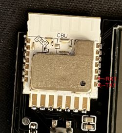 Close-up of a circuit board with RX1 and TX1 pins marked.