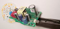 Internal Electronics of a Smart Bulb with TLSR8258 Chip Assembled circuitry of a smart bulb showing capacitors and TLSR8258 chip.