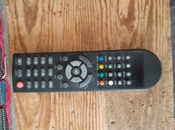 Remote control for DVB-T tuner Opticum HD N2 on wooden surface