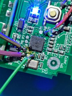 Close-up of a circuit board with electronic components, including wires and chips.