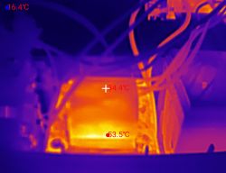 Thermal image of a device interior with a transformer and temperature readouts 16.4°C, 34.4°C, 53.5°C