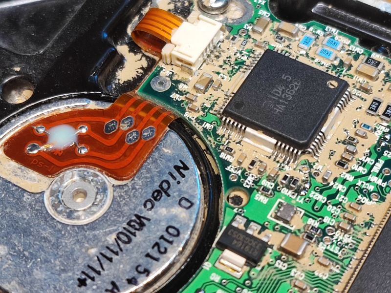 Interior of a Flood-Damaged Hard Drive Close-up of internal components of a damaged hard drive with electronics.