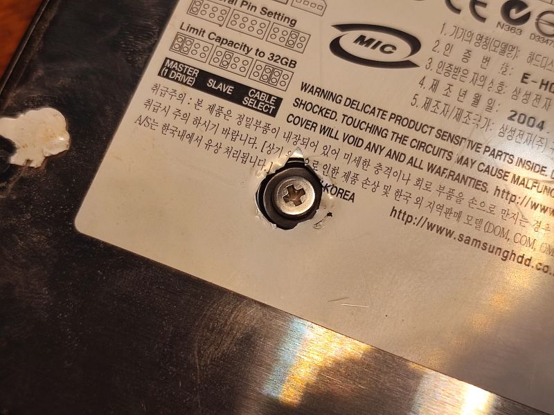 Samsung Hard Drive Warning Label Samsung hard drive casing with a warning label and visible screw.