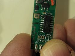 Close-up of an electronic module with markings on the circuit board.