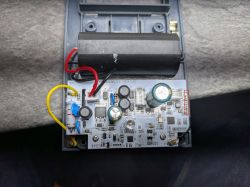 Electronic circuit board in open enclosure Open enclosure with visible circuit board and connected wires.