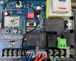 Close-up of an ESP module on a central board with unused wired control contacts.