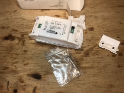 Wi-Fi ON/OFF relay module and mounting components on a table