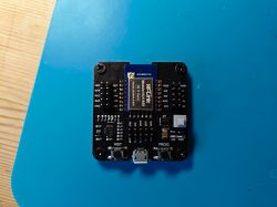 Universal ESP downloader adapter with HLK-B35 module on a blue background.