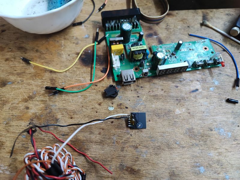 Electronic Board with Wires on Table Electronic board with soldered wires on a wooden table.
