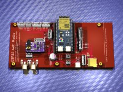 PCB with an ESP32 module on a metallic surface.