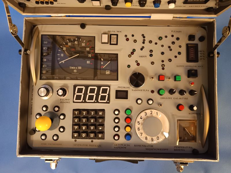 Voyager 3 Control Panel Toy in Suitcase Control panel of the Voyager 3 Expedition Control Center toy in a suitcase, featuring various buttons, indicators, a joystick, rotary dial, and displays.