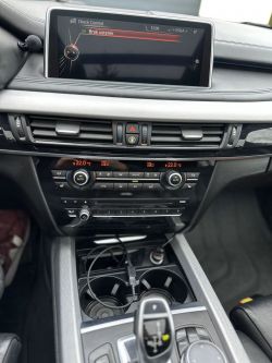 Car interior with visible central console and navigation screen.