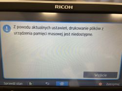 Wyświetlacz urządzenia Ricoh z komunikatem o niedostępności drukowania z pamięci USB.