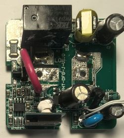PCB board with various electronic components including capacitors and a relay.