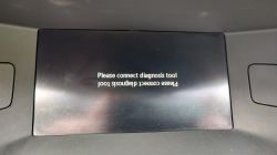 Car display screen with an upside-down message Please connect diagnosis tool.