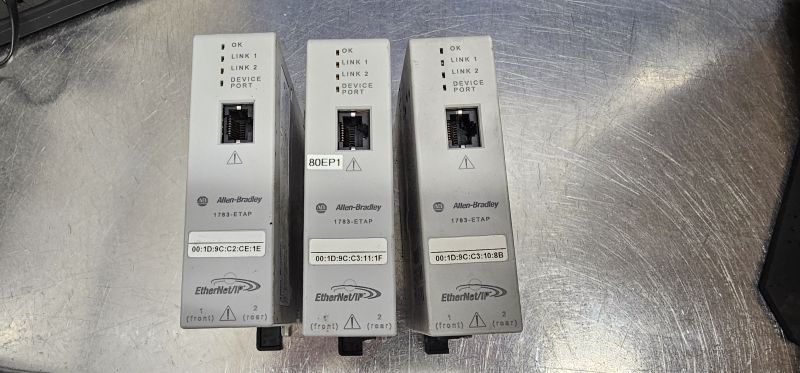 Three Allen‑Bradley 1783‑ETAP modules with Ethernet ports and LED indicators on a metal surface