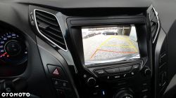 View of a car's rearview camera screen displaying a parking space.