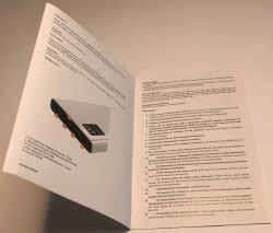 Open power bank manual showing port diagram and safety instructions