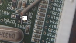 Close-up of a PCB section with label D704, a wire, and a 0V note at an electronic component.