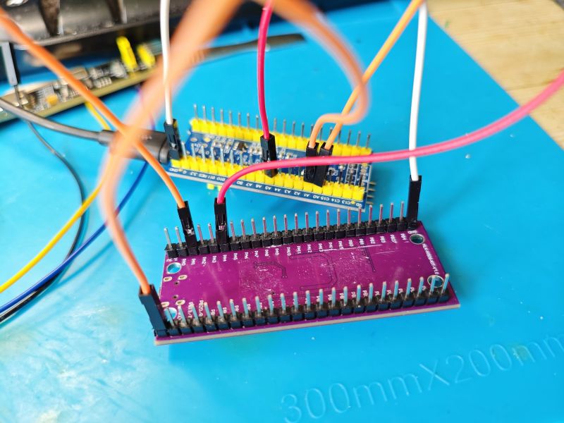 Connected electronic modules on a work mat Two electronic modules connected with wires on a blue work mat.