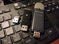USB WiFi Adapters on Keyboard Various-sized USB WiFi adapters on a keyboard.