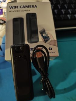 Mini WiFi camera with USB cable and box Mini WiFi camera, USB cable, and packaging with device illustration