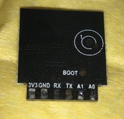 Electronic module with labels on a black background.