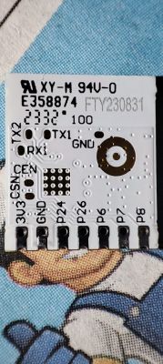 Close-up of an electronic module with various markings, pin numbers, and connectors on the circuit board.