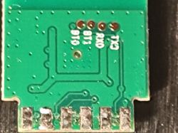 Close-up of a PCB with labeled pins RX0, TX0, B1, and B1.
