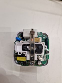 Interior of a Tuya smart plug showing the PCB and electronic components.