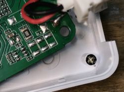 Circuit Board with Components and Mounting Screw Close-up of a circuit board with visible components and mounting screw