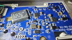 Close-up of a blue PCB with SMD parts and a module labeled “JK-030 DC12.0V”.