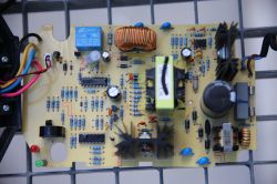 Close-up of a PCB with electronic components, coils, capacitors, and heat sinks