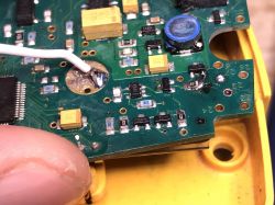 Close-up of a damaged PCB with electronic components.