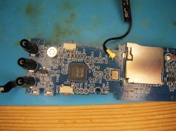 PCB with Beken BGA chip and microSD card socket Close-up of a blue PCB with BGA chip, microSD socket, and black connectors