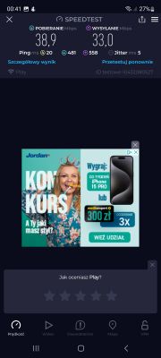 Zrzut ekranu z wynikami testu prędkości internetu z aplikacji Speedtest. Pobieranie 38,9 Mb/s, wysyłanie 33 Mb/s. Ping 20 ms. Reklama konkursu w tle.