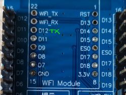 Close-up of a WiFi module with pins, one marked as D12 TX.