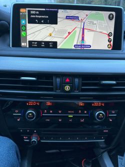 Car navigation screen with climate control panel.