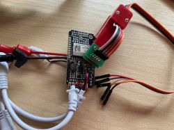 CB3S/BK7231N LED Controller with Connected Wires and Pogo Pin Adapter LED controller board with connected wires, pogo pin adapter, and measurement probes attached.
