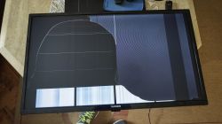 Telefunken TV with cracked LCD screen showing black blotches and vertical stripes