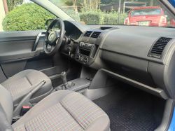 Car interior with a view of the dashboard, steering wheel, and front seats.