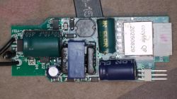 Close-up of a power supply PCB with capacitors and a shielded module labeled “cozylife QP”