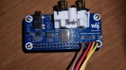 Waveshare PCM5122 audio board with connected wires on a wooden surface