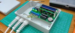 Custom-built timer with electronic components inside a plastic enclosure.