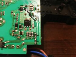 Close-up of a green circuit board with various electronic components such as resistors and capacitors.