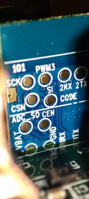 Close-up of a PCB in an electronic device Close-up of the inside of an electronic device, showing markings on the PCB.