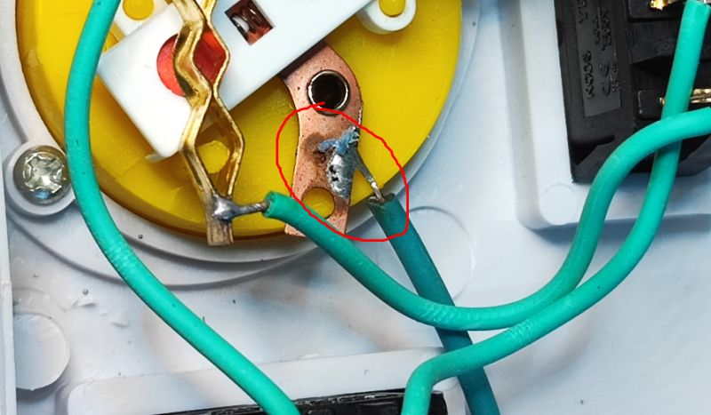 Poor Soldering in Power Strip Poor soldering of a wire in a power strip.