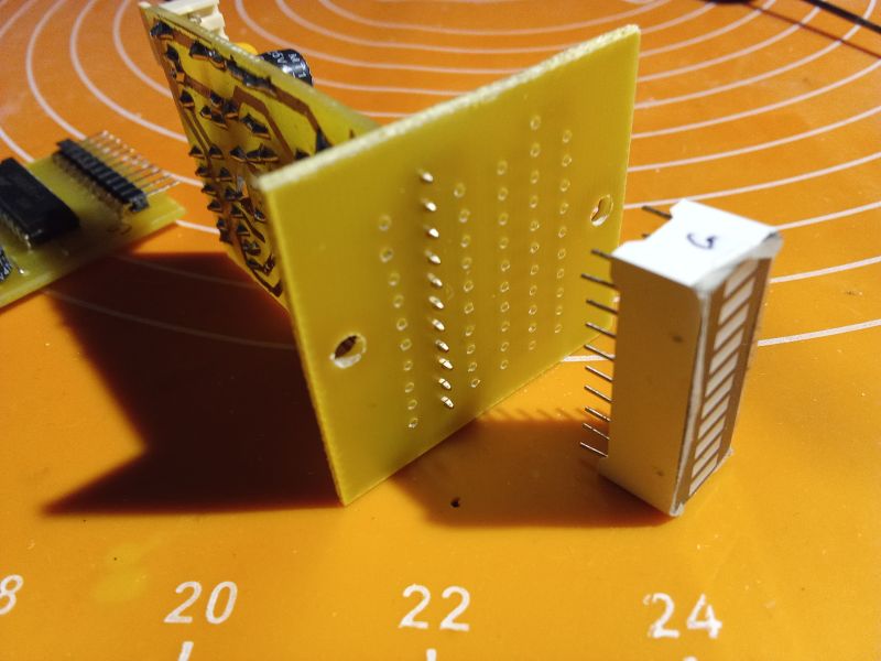 Electronic components on an orange mat with markings.