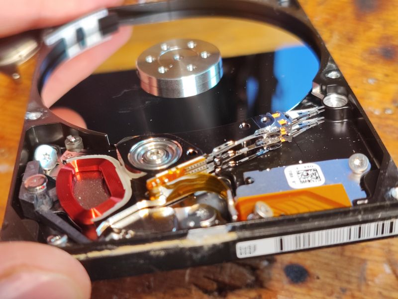 Inside of a Hard Disk Drive with Visible Components Inside of a hard disk drive showing electronic components and signs of moisture.
